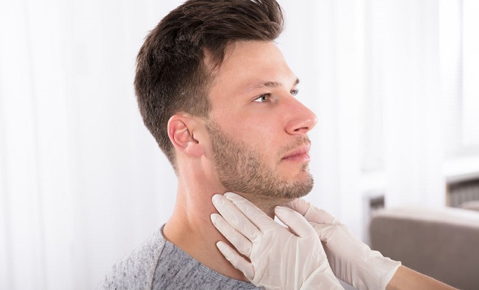 doctor performing physical exam palpation of the thyroid gland
